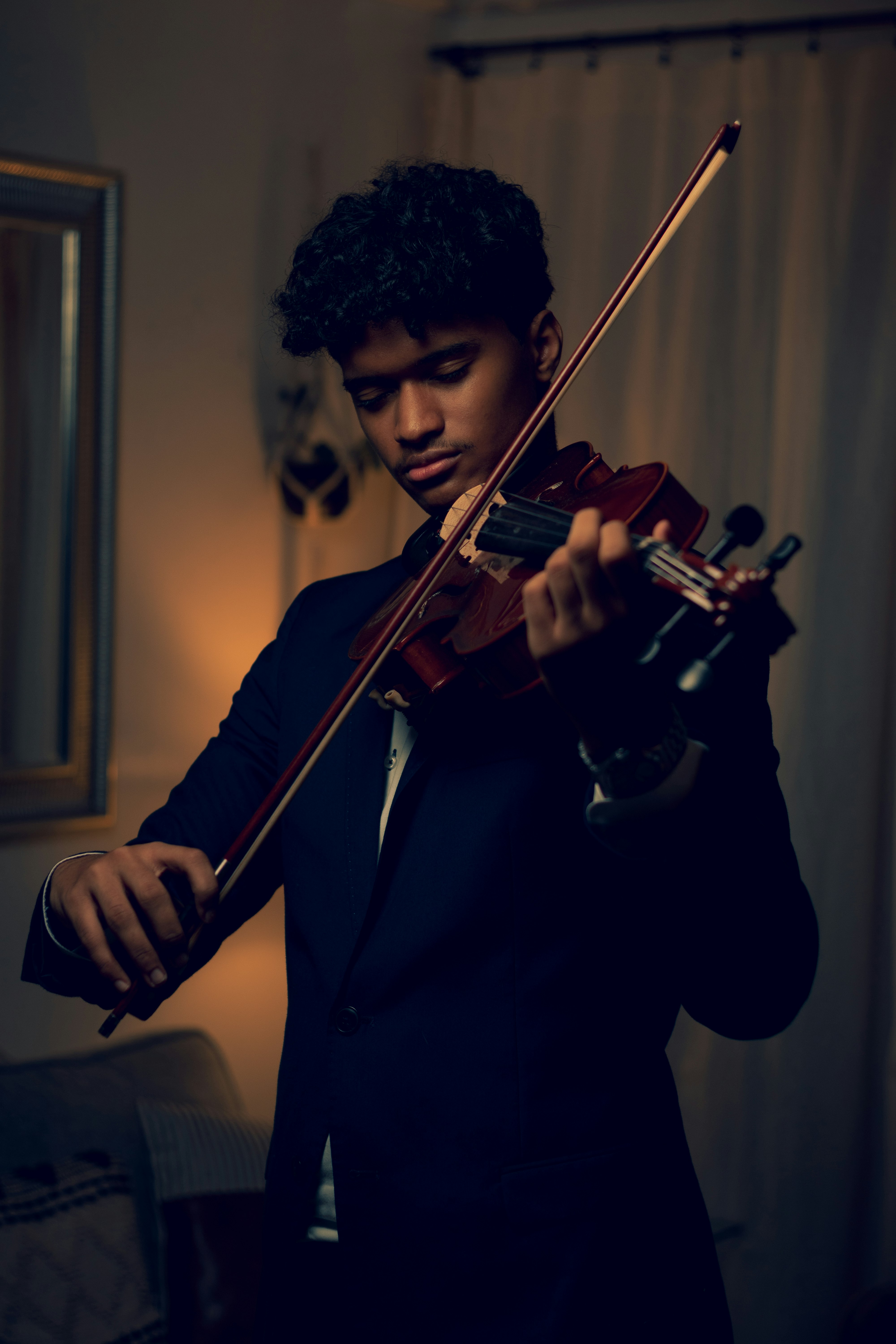 man playing violin in grayscale photography